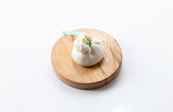 Buratto cheese on a wooden board. On white background.