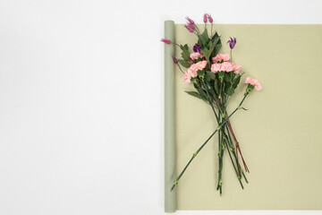 Gift or present  paper and carnation flower on table from above. Flat lay styling. Copy space for text