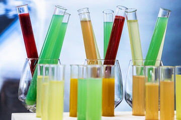 medical test tubes with liquids of different colors, juices, drinks or alcoholic cocktails