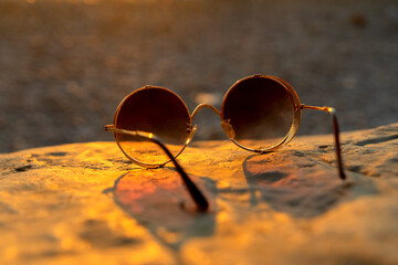 Sunglasses against sunset