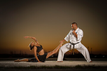 Fototapeta na wymiar Karate fighter and a girl gymnast training their abilities at sunset