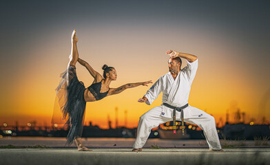 Beautiful girl gymnast and karate fighter practicing poses at sunset 