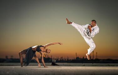 Karate fighter and girl gymnast practising poses at sunset
