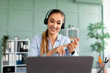 Online education. Young female teacher having video conference chat with students, talking to webcam and explaining