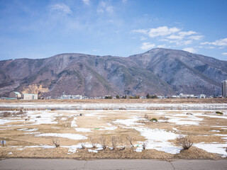 scenery of winter mountain range and snow-covered riverbank of chikuma river in nagano