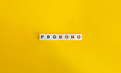Pro Bono phrase on letter tiles on bright orange background. Minimal aesthetics.