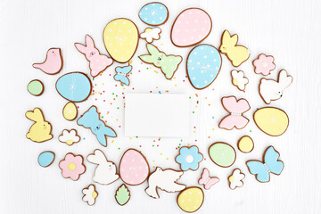 Easter greeting card with gingerbread cookies. Easter spring decorative composition with homemade easter cookies in shape of funny rabbit and eggs