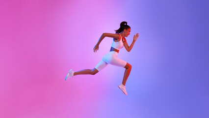 Fototapeta na wymiar Fit Lady Jumping In Mid-Air Exercising Over Neon Background
