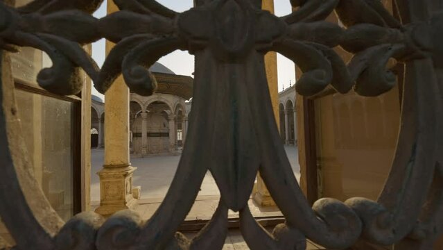 Great Mosque of Muhammad Ali Pasha or Alabaster Mosque in Cairo, Egypt. Sun breaks through the lattice of window in the mosque Muhammad Ali Pasha, courtyard is visible inside. Citadel of Cairo. Gimbal