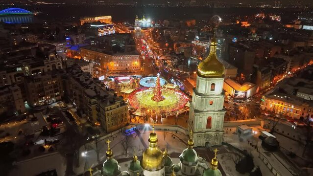 Aerial view of night New Year Kiev, Ukraine. Flying over the city center of Kiev, St. Sophia Cathedral and the lights of the city decorated with garlands
