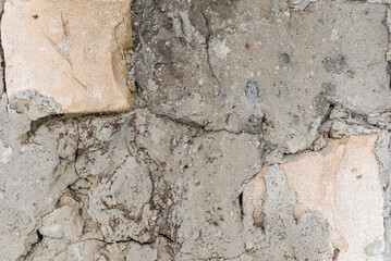 Cracked concrete wall gray cement surface background.cracked grey stone wall in winter.close-up.