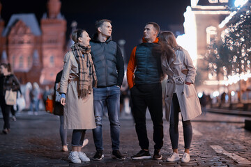 red square evening winter, a group of friends for a walk new year christmas moscow russia
