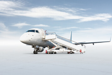 White passenger airliner with boarding steps at the airport apron isolated on bright background with sky