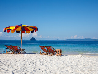 Colorful sun umbrella and chairs on Khai Nok island is one of the most famous island in Thailand...