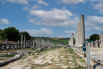 Fototapeta na wymiar Ancient city of Perge near Antalya Turkey. Columned street and ruins.. Believed to have been built in the 12th to 13th centuries BC. Blue Sky.