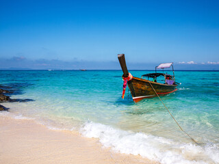 Travel trip by thai traditional long tail boat, white sand, blue water. Phi Phi Islands popular...