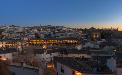 village of chinchon at sunset with orange colors and village lights on