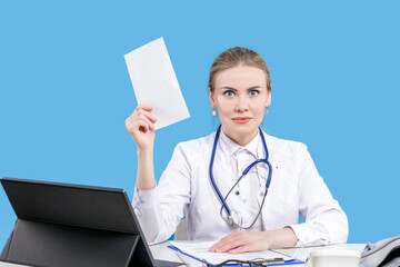 Therapist. Hospital. Chief Physician. A female doctor sits at a desk on a blue background, writes...