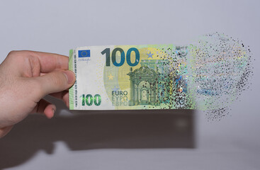 euro bill held in one hand decomposes and dissolves due to inflation