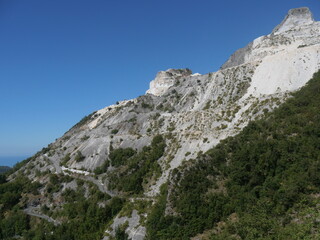 Fototapeta na wymiar panorama from Colonnata on marble quarries among the green of the Apuan Alps from the village of Codena