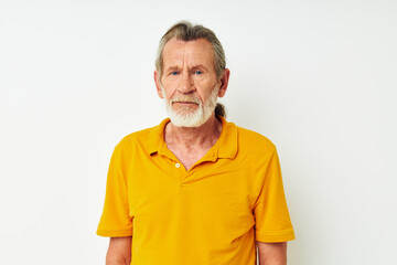 Senior grey-haired man hand gesture gray beard fun light background