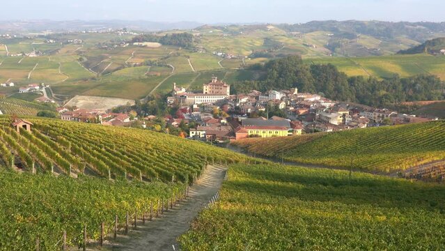 Beautiful hills and vineyards during fall season surrounding Barolo village. In the Langhe region, Cuneo, Piedmont, Italy.