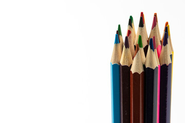 Colored pencils in a stack isolated on a white background. close-up, copy space