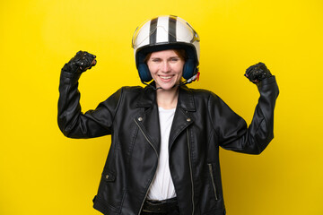 Young English woman with a motorcycle helmet isolated on yellow background doing strong gesture