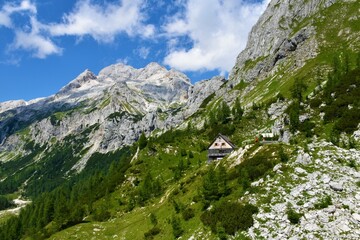 View of mountain Triglav in Julian alps and Triglav national park, Gorenjska, Slovenia and a mountain hut at Vodnikov dom bellow the slopes
