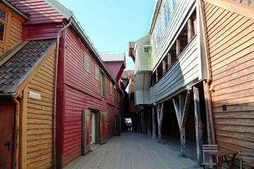 View of the narrow Bellgarden street with colorful wooden houses in Bergen on a clear sunny day,...