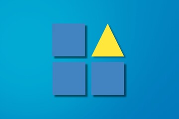 Blue toy cubes and yellow triangle on background. Concept of individuality, being different from others, leadership or unique ideas