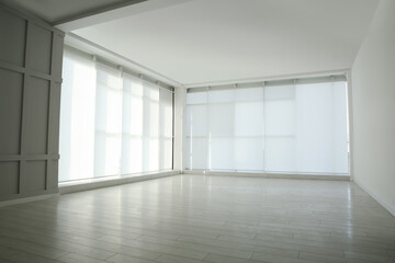 Empty room with panoramic windows and white wooden floor