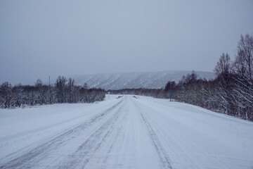 Snowy road with mountain landscape