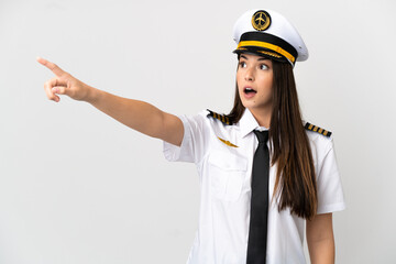 Brazilian girl Airplane pilot over isolated white background pointing away