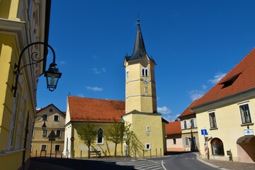 Fototapeta premium View of catholic church with a yellow facade at Kostanjevica na Krki in Dolenjska, Slovenia