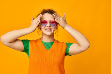 cheerful woman orange sweatshirts sunglasses multicolored glasses supply cropped view unaltered
