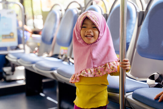 Muslim Little Girl With Hijab Riding Bus