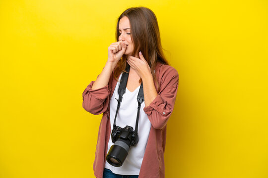 Young photographer caucasian woman isolated on yellow background is suffering with cough and feeling bad