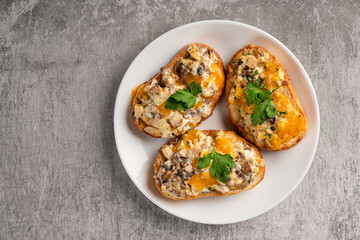 Bruschetta with egg, cheese, mushrooms and herbs in a plate on a gray background. Horizontal orientation, copy space, top view