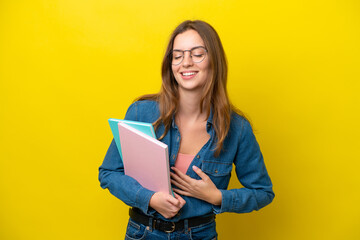 Young student caucasian woman isolated on yellow background smiling a lot