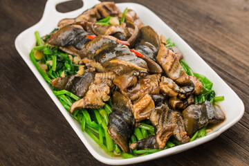 Chinese Cuisine: fried eel with a plate of cabbage