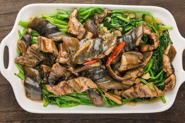 Chinese Cuisine: fried eel with a plate of cabbage