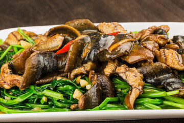 Chinese Cuisine: fried eel with a plate of cabbage
