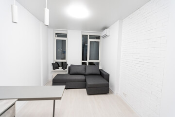 Fototapeta premium Modern studio flat with small kitchen, sofa.