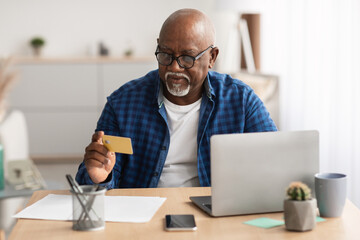 Senior African American Businessman Shopping Using Card And Laptop Indoor