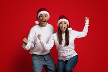 Christmas Joy. Cheerful Emotional Couple In Santa Hats Exclaiming With Excitement