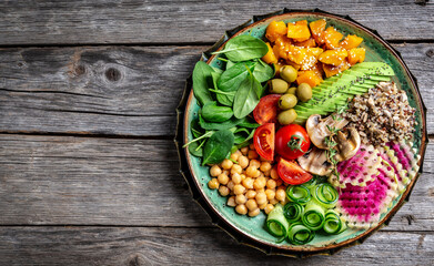 Buddha Bowl with Quinoa, Avocado, mushrooms, cucumber, chickpeas, spinach, tomatoes, vegetables salad. Clean eating, dieting, vegan food concept. top view