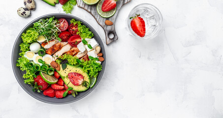 Ketogenic diet food, chicken fillet, quinoa, avocado, avocado, feta cheese, quail eggs, strawberries, nuts and lettuce. healthy meal concept, top view