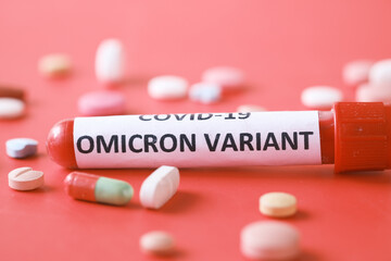omicron variant corona virus blood test tube and medical pills on red 