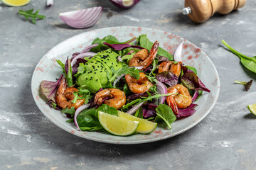 Green salad with avocado and shrimps salad. Seafood concept. Tasty veg mixed leaves, grilled prawn shrimps. Delicious breakfast or snack. Detox diet. Vegetarian lunch. Weight loss